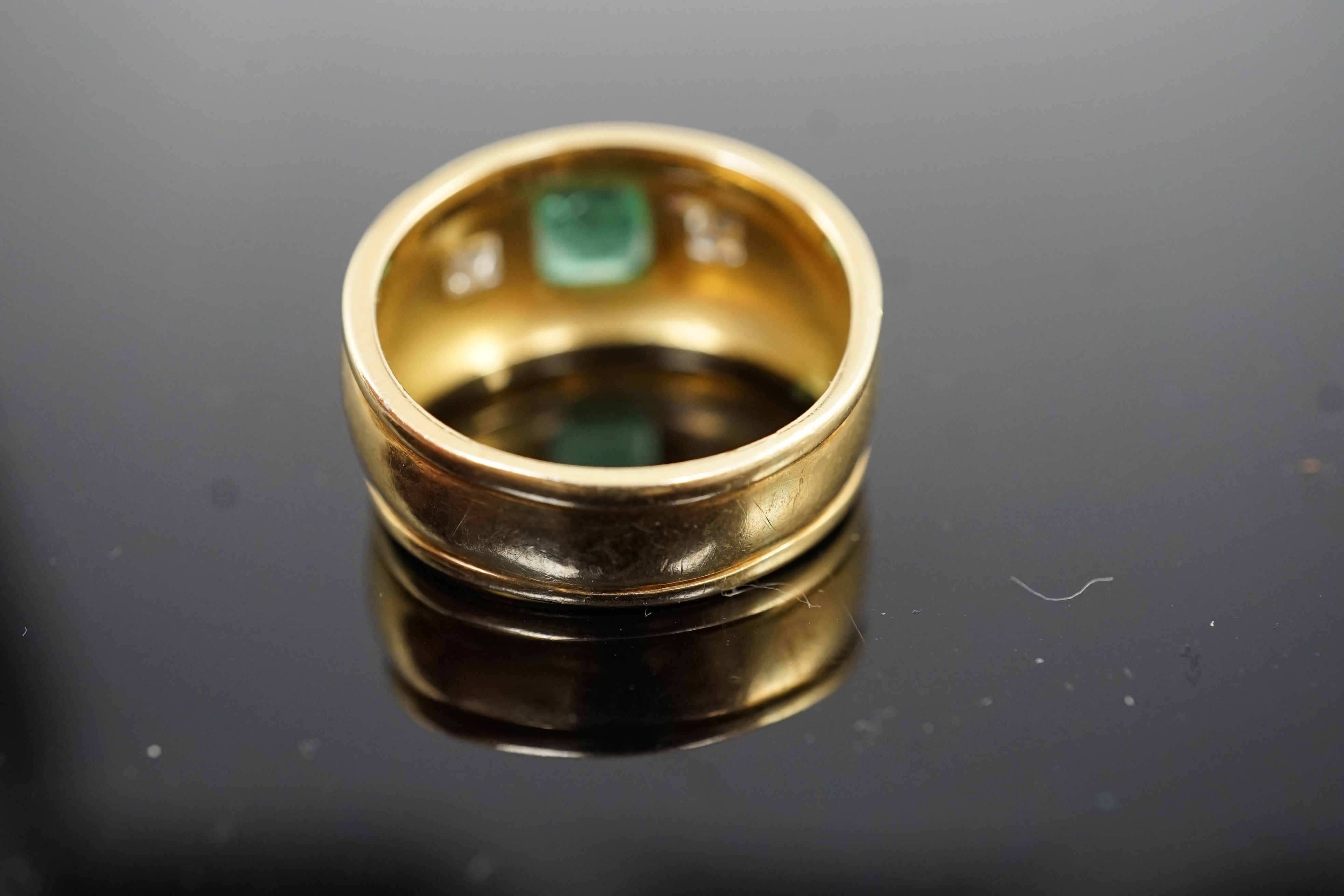 A modern Theo Fennel style 18ct gold, single stone collet set emerald and two stone gypsy set princess cut diamond dress ring